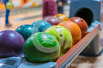 Colorful bowling balls on ball return close up Stock Photo