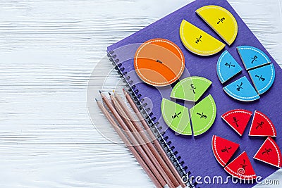 Colorful bright fractions in mathematics on white wooden table. interesting math for kids children. Education, back to school Stock Photo