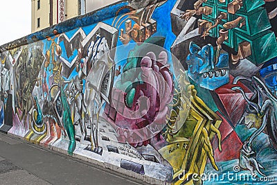 Colorful bright graffiti on the Berlin Wall on the East Side. The world`s largest open-air art gallery Editorial Stock Photo