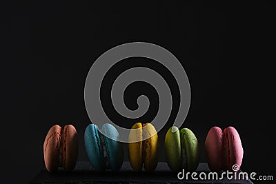 Colorful and bright macarons cookies black background Stock Photo