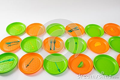 Colorful bright plastic plates setting apart and having forks and skewers Stock Photo