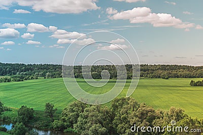 Colorful Bright Sunny Green Field Landscape With Blue Cloudy Sky, Trees And Hills Stock Photo