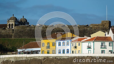 Colorful, bright view of houses and fort in Angra do Heroismo Stock Photo