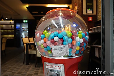 Colorful bubble gum in Coin operated gumball machine. Carousel Gumball Machine Bank kept outside a shop. - Dubai UAE January 2020 Editorial Stock Photo