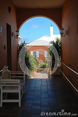 Colorful building through archway in Bermuda Stock Photo