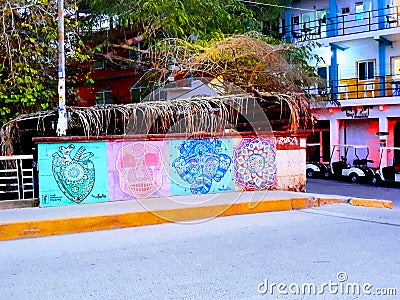 Colorful building and street mural of tribal art on bridge in sayulita amongst tropical plants Editorial Stock Photo