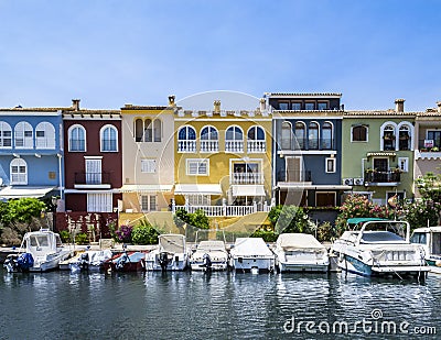 Colorful buildings near the sea with the boats parked in the front. Editorial Stock Photo