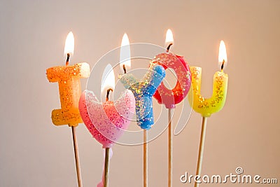 Colorful burning candles making I love you Stock Photo