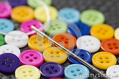 Colorful buttons on work table close up. Clothing sewing Stock Photo