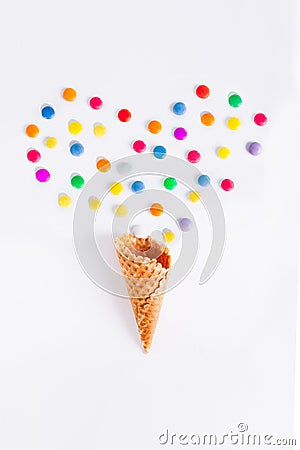 Colorful candies in the shape of a heart and ice cream cone on the white background. Place for lettering. Top view, flat lay Stock Photo