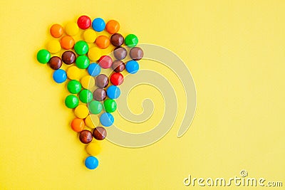 Colorful candies on yellow background Stock Photo