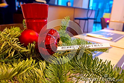 Colorful candlestick with red balls and green pine branches. Preparing for Christmas and New Year. Stock Photo