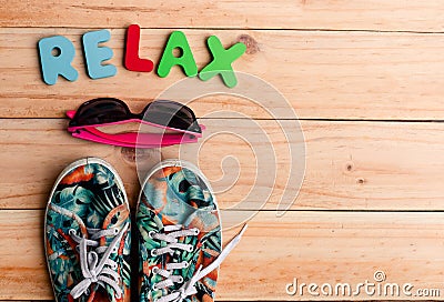 the colorful Canvas shoe and sunglasses with RELAX alphabet on w Stock Photo