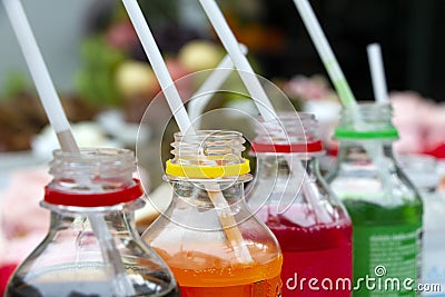 Colorful of carbonated soft drink pop soda bottles with plastic straw. Plastic bottles of assorted carbonated in variety of colors Stock Photo