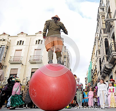 Colorful carnival parade down the street with clowns and jugglers Editorial Stock Photo