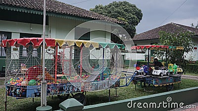 Colorful cart toys parking on the side of street in front of house Editorial Stock Photo