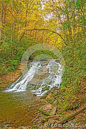 Colorful Cascade in the Fall Forest Stock Photo