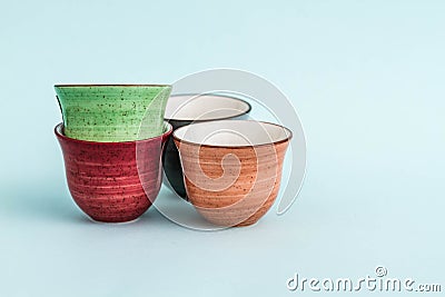 Colorful Ceramic Espresso Cups on Green Background Stock Photo