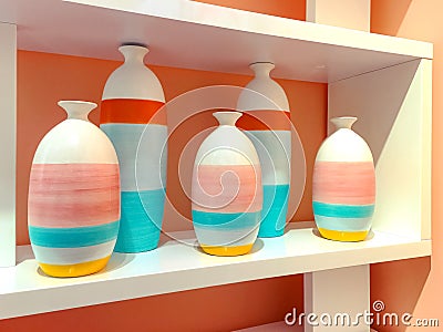 Colorful ceramic vases on a shelf Stock Photo