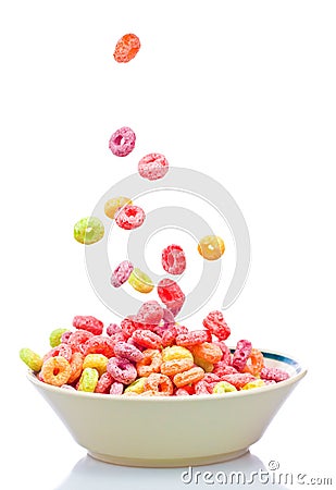 Colorful cereal falling on a white bowl Stock Photo