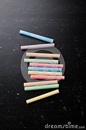 Colorful chalks on blackboard for back to school poster. Stock Photo