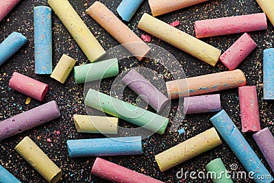 Colorful chalks on blackboard. Vintage back to school card. Stock Photo