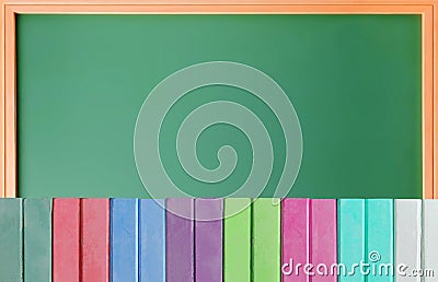 Colorful chalks over school blackboard Stock Photo