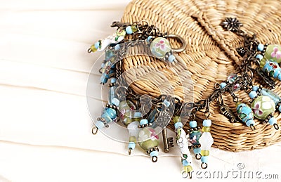 Colorful charm bracelet on cream background Stock Photo