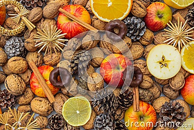 Colorful Christmas background.Cinnamon rols,aplles,nuts,spices,orange slice.Seasonal decoration. Advent rustic concept.Home made Stock Photo