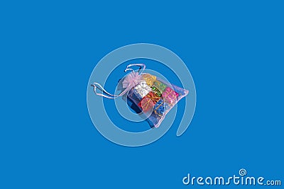 Colorful Christmas decorative gift boxes isolated on blue background. Christmas gift bag idea Stock Photo