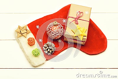 Colorful Christmas or New Year decoration include gift with rose string, yellow bow, Santa Claus red sock, red ball Stock Photo