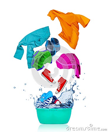Colorful clothes flying out from blue wash bowl on white Stock Photo
