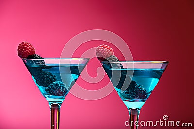 Colorful cocktails garnished with berries, studio shot Stock Photo
