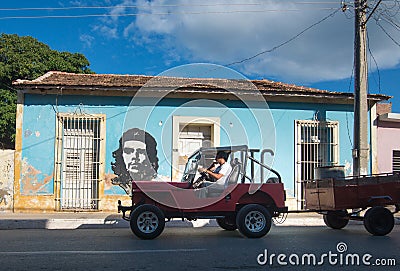 Colorful Colonial aged town with classic car, building, revolution wall, modern street in Trinidad, Cuba, America. Editorial Stock Photo