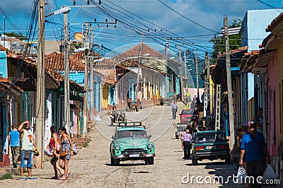 Colorful Colonial Caribbean historic village with cobblestone street, classic car and house, Trinidad, Cuba, America. Editorial Stock Photo