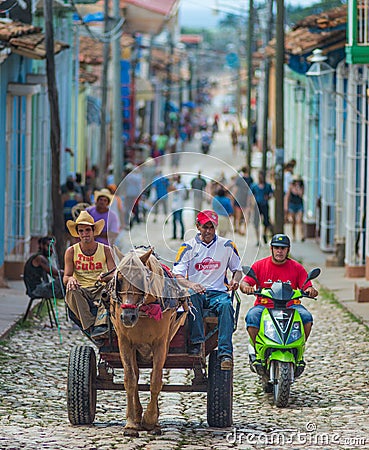 Colorful Colonial old crowd town with classic carriage, farmer, cobblestone street in Trinidad, Cuba, America. Editorial Stock Photo