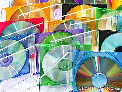 Colorful compact discs in boxes stacked in a pile as background Stock Photo