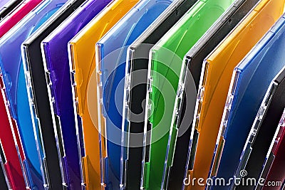 Colorful compact discs in boxes stacked in a pile as background Stock Photo