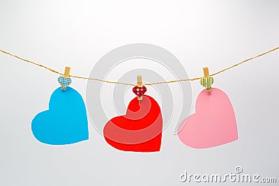 Colorful cutting paper hearts hanging rope with wooden clip for Happy Valentine`s Day Stock Photo