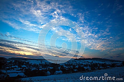 Colorful dawn sunrise in winter over hills forest in countryside Stock Photo