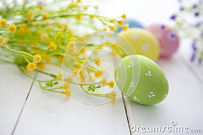 Colorful decorated easter eggs on white wood background. Stock Photo