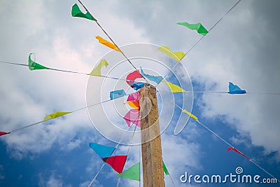 Colorful decoration flags against blue sky background on a summer festival happy and joyful playing kids, games. summer blue . Stock Photo