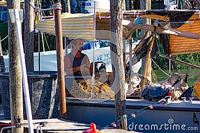 Colorful detail of a fishing boat just moored on the shores of Cortellazzo in the province of Venice. Editorial Stock Photo