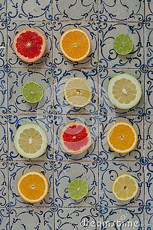 Colorful display of sliced fruit arranged in neat square patterns on a tiled surface Stock Photo