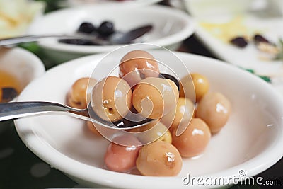 A Colorful and Diverse Assortment of Edible FruitLike Spheres Beautifully Arranged in a Bowl Stock Photo