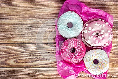 Colorful donuts on wooden background empty space for text Stock Photo