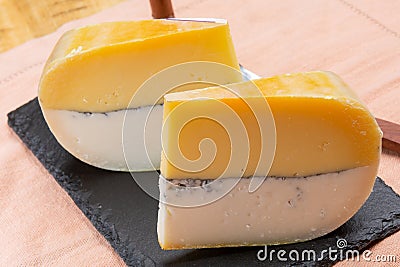 Colorful Double Dutch cheese, hard cheese made from cow milk and goat milk with layer of black mold inside Stock Photo