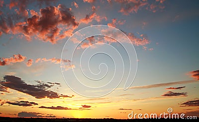 Colorful dramatic sunset on sky with bizarre clouds Stock Photo