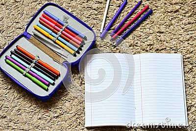 Colorful drawing pencils and open epmty notebook Stock Photo