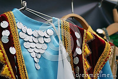 Colorful dresses decorated by coins. Stock Photo